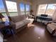 Living room with sofa, armchair, and large windows at 2273 S Seminole Dr, Apache Junction, AZ 85119