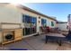 Backyard patio with seating, grill station, and lounge chair at 2329 N Recker Rd # 94, Mesa, AZ 85215