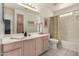 Bathroom with light wood cabinets, a shower/tub combo, and a single sink at 2329 N Recker Rd # 94, Mesa, AZ 85215