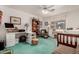 Bedroom with a workspace, ceiling fan and teal carpet at 2329 N Recker Rd # 94, Mesa, AZ 85215