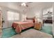 Spacious bedroom with a peach colored bedspread and ceiling fan at 2329 N Recker Rd # 94, Mesa, AZ 85215