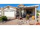 Front view of the house with a covered patio, desert landscaping, and a two-car garage at 2329 N Recker Rd # 94, Mesa, AZ 85215