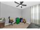 Simple bedroom with ceiling fan and window coverings at 2405 E Beverly Rd, Phoenix, AZ 85042