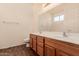 Double vanity bathroom with wood cabinets at 244 W Wier Ave, Phoenix, AZ 85041