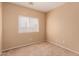 Bright bedroom with neutral walls and carpet at 244 W Wier Ave, Phoenix, AZ 85041