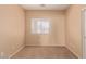 Simple bedroom with window and carpet at 244 W Wier Ave, Phoenix, AZ 85041