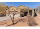 House with a two-car garage, mature trees, and desert landscaping at 244 W Wier Ave, Phoenix, AZ 85041