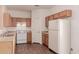 Kitchen with oak cabinets, white appliances, and a pantry at 244 W Wier Ave, Phoenix, AZ 85041