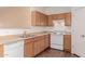 Kitchen with oak cabinets, white appliances, and a double sink at 244 W Wier Ave, Phoenix, AZ 85041