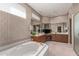 Spa-like bathroom with a large soaking tub and double vanity at 24826 S Stoney Lake Dr, Sun Lakes, AZ 85248