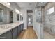 Modern bathroom with double vanity and marble shower at 26123 N 20Th Dr, Phoenix, AZ 85085