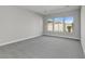 Simple bedroom with grey carpet and large windows at 26123 N 20Th Dr, Phoenix, AZ 85085