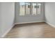 Bright bedroom with wood-look floors and large windows at 26123 N 20Th Dr, Phoenix, AZ 85085