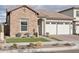 Single-story home with stone exterior, three-car garage, and landscaped front yard at 26123 N 20Th Dr, Phoenix, AZ 85085