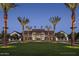 Elegant community clubhouse at dusk with palm trees at 26123 N 20Th Dr, Phoenix, AZ 85085