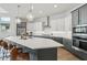 Modern kitchen features gray and white cabinets, quartz countertops, and a large island at 26123 N 20Th Dr, Phoenix, AZ 85085