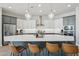 Modern kitchen with two-toned cabinets, white quartz countertops, and stainless steel appliances at 26123 N 20Th Dr, Phoenix, AZ 85085