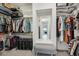 Large walk-in closet with ample shelving and a built-in bench at 26123 N 20Th Dr, Phoenix, AZ 85085