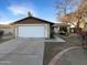 House exterior featuring a two-car garage and well-maintained landscaping at 2843 E Pershing Ave, Phoenix, AZ 85032