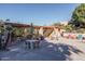 Community patio with tables, chairs, and a shaded pergola at 3031 N Civic Center Plz # 228, Scottsdale, AZ 85251