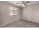 Spacious bedroom with carpet flooring, window with blinds, and ceiling fan at 3104 W Carlos Ln, San Tan Valley, AZ 85144