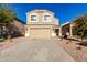 Two-story house with tan exterior, two-car garage, and landscaping at 3104 W Carlos Ln, San Tan Valley, AZ 85144