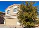 Two-story house with tan exterior, two-car garage, and landscaping at 3104 W Carlos Ln, San Tan Valley, AZ 85144