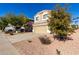 Two-story house with tan exterior, two-car garage, and landscaping at 3104 W Carlos Ln, San Tan Valley, AZ 85144