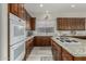 Modern kitchen with granite countertops, stainless steel appliances, and dark wood cabinets at 31847 N 53Rd St, Cave Creek, AZ 85331