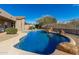 Inviting kidney-shaped pool with waterfall feature and large rocks at 31847 N 53Rd St, Cave Creek, AZ 85331