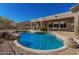 Spacious backyard with a curved pool and patio area at 31847 N 53Rd St, Cave Creek, AZ 85331