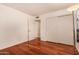 Simple bedroom with wood floors and double door closet at 3519 W Emig Rd, Phoenix, AZ 85053