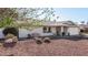 Single story home with a red bench and gravel landscaping at 3519 W Emig Rd, Phoenix, AZ 85053