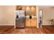 Kitchen with stainless steel refrigerator and wood cabinetry at 3519 W Emig Rd, Phoenix, AZ 85053