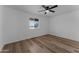 Bright bedroom with wood-look floors and ceiling fan at 3815 E Cortez St, Phoenix, AZ 85028