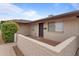 Tan brick home's front entrance with a brown door and small patio at 3815 E Cortez St, Phoenix, AZ 85028