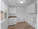 Bright laundry room with white cabinets and vinyl flooring at 3815 E Cortez St, Phoenix, AZ 85028