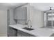 Modern kitchen with gray cabinets and white countertops at 3830 E Lakewood E Pkwy # 2047, Phoenix, AZ 85048