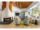 Modern living room with a fireplace and wood-beamed ceiling at 39349 N 107Th Way, Scottsdale, AZ 85262