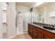 Bathroom with granite double vanity and walk-in shower at 42593 W Falling Star Ct, Maricopa, AZ 85138