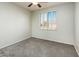 Bright bedroom with ceiling fan and plantation shutters at 42593 W Falling Star Ct, Maricopa, AZ 85138