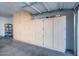 Garage with built-in storage cabinets and shelving at 42593 W Falling Star Ct, Maricopa, AZ 85138