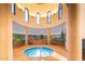 Relaxing hot tub with scenic mural and arched windows at 42593 W Falling Star Ct, Maricopa, AZ 85138