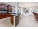 Kitchen with a curved island and dark wood cabinets at 42593 W Falling Star Ct, Maricopa, AZ 85138