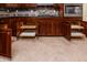 Spacious kitchen with dark wood cabinets and granite countertops at 42593 W Falling Star Ct, Maricopa, AZ 85138