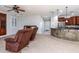 Living room with two armchairs and view of kitchen at 42593 W Falling Star Ct, Maricopa, AZ 85138