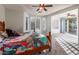 Main bedroom with wood bed frame and patterned bedding at 42593 W Falling Star Ct, Maricopa, AZ 85138