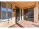 Covered patio with sliding glass doors and shutters at 42593 W Falling Star Ct, Maricopa, AZ 85138