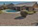 Home's backyard with a pool and gravel landscaping at 4302 E Rockledge Rd, Phoenix, AZ 85044