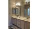 Bathroom with double vanity, large mirrors, and a window at 4302 E Rockledge Rd, Phoenix, AZ 85044